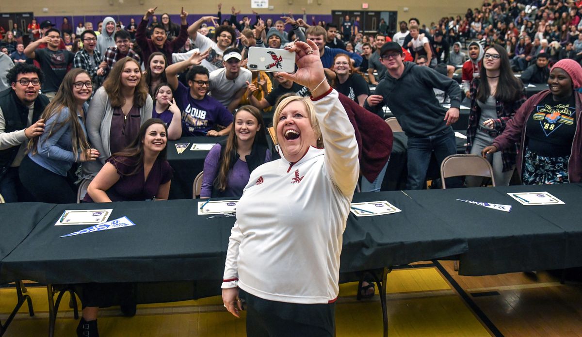 Rogers High School Principal Lori Wyborney takes a selfie of a gathering of students during Senior Signing Day Friday. The seniors walked across a stage, said their names and announced intentions for further education next year. (Dan Pelle / The Spokesman-Review)