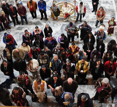OLYMPIA -- Members of Native American tribes from around Washington gather in the Capitol Building outside the Senate doors to sing after legislation restoring authority to their local court systems was signed by Gov. Chris Gregoire on Monday, March 19. (Jim Camden)