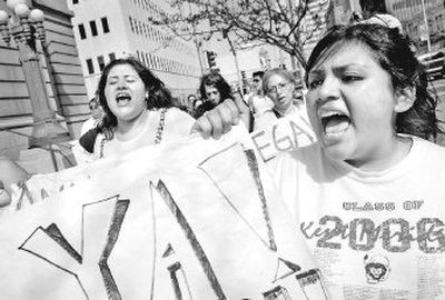 
Eastern Washington University freshman Zuri Cambron, right, marches with a group to the U.S. Courthouse in Spokane to call attention to the need for immigration reform Tuesday afternoon. 
 (Holly Pickett / The Spokesman-Review)