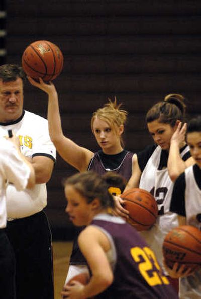
Wing Kasey Jurich listens to University High School girls basketball coach Mark Stinson at practice. She is expected to be a key inside force for the Titans after she fully recovers from an ankle injury she suffered during her successful volleyball season. 
 (J. BART RAYNIAK / The Spokesman-Review)