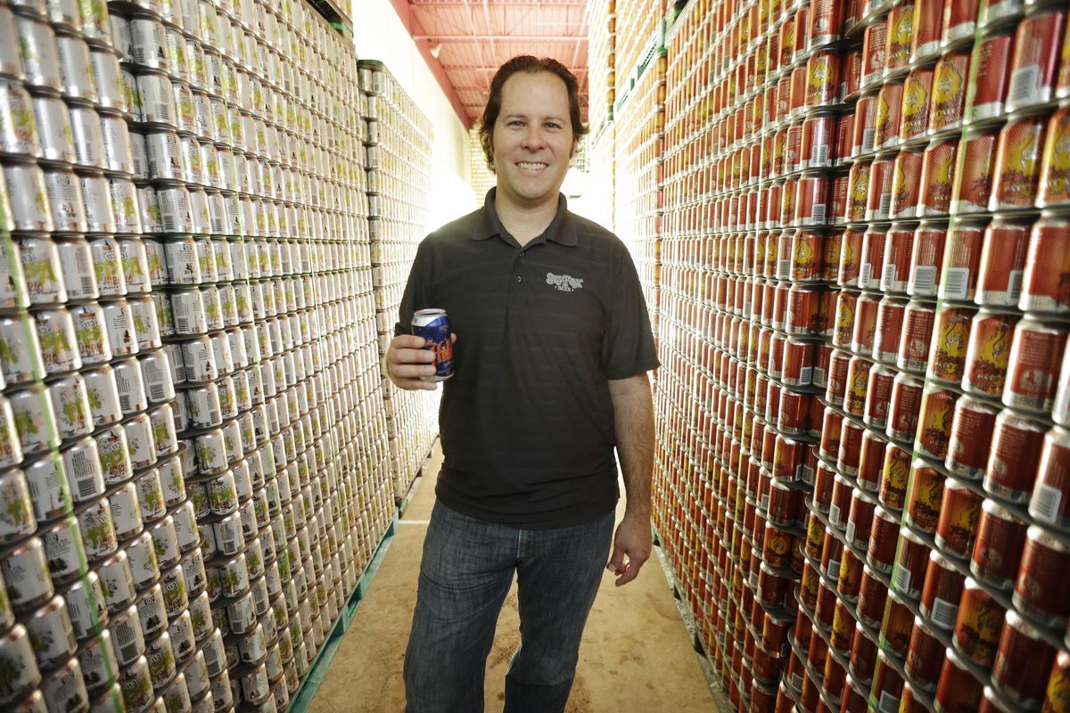 Brewmaster Brian O’Reilly holds a can of Helles Golden Lager with a 360 Lid as he poses for a portrait at the Sly Fox Brewing Co. in Pottstown, Pa. (Associated Press)