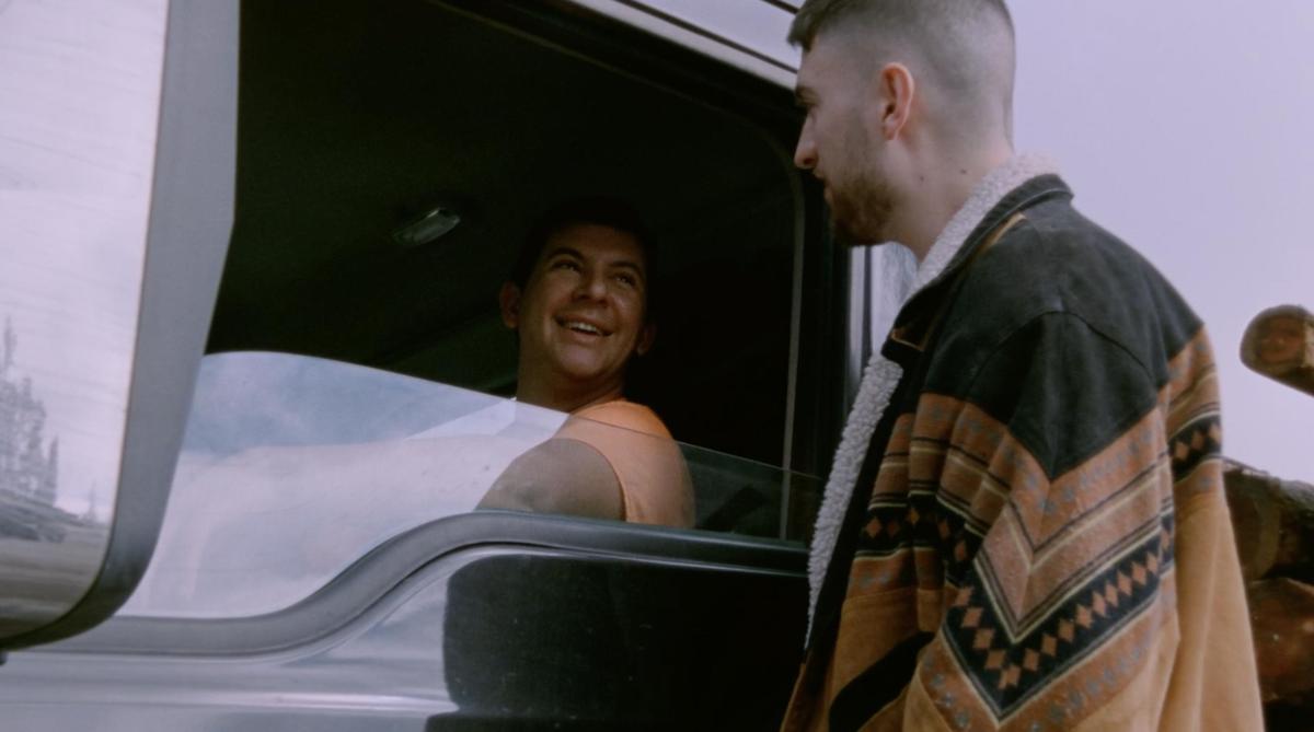 Atdhe Trepca, a filmmaker, asks a truck driver if he’s happy, in a still from a documentary. The man shares that he’s going through a divorce.
