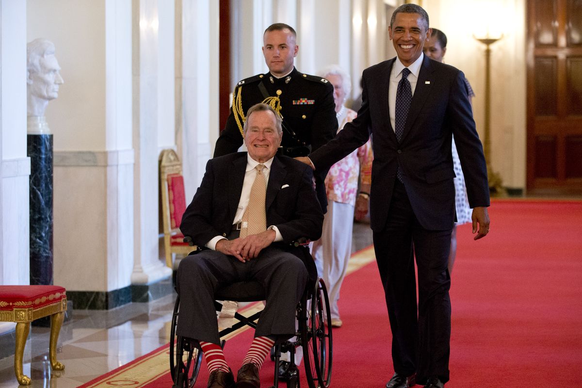 President Barack Obama and former President George H.W. Bush arrive to present the 5,000th Daily Point of Light Award to a retired couple from Iowa on Monday. (Associated Press)