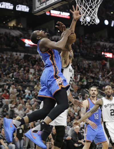 Kevin Durant, fouled by San Antonio’s Tim Duncan, scored 23 points on Tuesday in Oklahoma City’s 95-91 win. (Eric Gay / Associated Press)