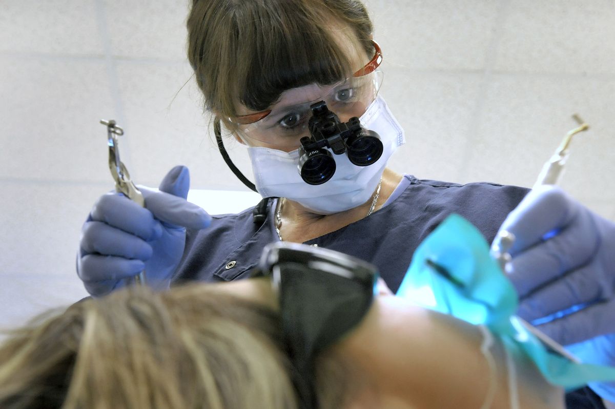 Dental assistant Jill Metlow  works on patient Autum  Whitworth in the Spokane Community College dental lab recently. Metlow works for a Chewelah dentist.  (Photos by Christopher Anderson / The Spokesman-Review)