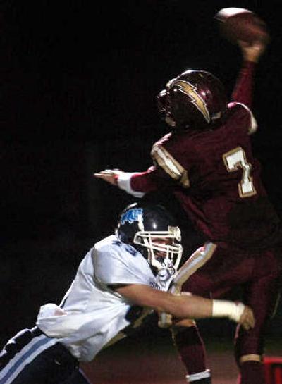 
 University quarterback Dan Jordan is forced to throw as Gonzaga Prep's Ian Orlando goes for the sack during a game in September. 
 (Holly Pickett / The Spokesman-Review)