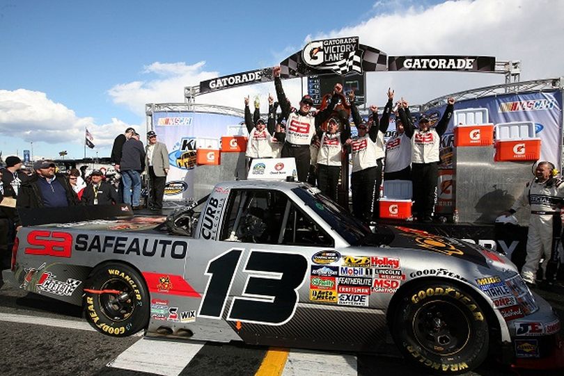 Johnny Sauter climbs out of the No.13 Safe Auto / 104 WTQR Country Chevrolet in victory lane after winning the Kroger 250 at Martinsville Speedway (Photo Credit: Jerry Markland/Getty Images for NASCAR) (Jerry Markland / Getty Images North America)