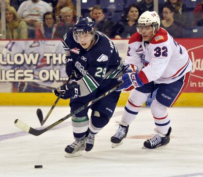 Spokane's Todd Fiddler, right, tries to slow down the Seattle Thunderbirds's Roberts Lipsbergs. (Jesse Tinsley)