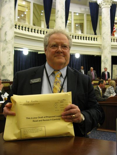 A grim Rep. John Rusche, his voice nearly gone, with the new version of the child support enforcement bill that he wasn't allowed to introduce on Friday; per House rules, the new version he prepared was one word different from the rejected one, so that it wasn't identical. (Betsy Russell)