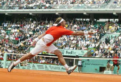 David Nalbandian of Argentina stretches to return the ball to Gustavo Kuerten of Brazil during their quarterfinal match.
(Associated Press / The Spokesman-Review)
