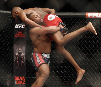 In this Jan. 3, 2015, file photo, Daniel Cormier, bottom, takes down Jon Jones during their light heavyweight title mixed martial arts bout at UFC 182 in Las Vegas. If Cormier wasn’t Jones’ bitter enemy, the UFC light heavyweight champion probably could could give sound advice to Jones, the troubled former champ. Instead, the steady Cormier realizes he needs a victory over his self-sabotaging archrival on Saturday, July 29, 2017, at UFC 214 to validate his own title reign. (John Locher / Associated Press)