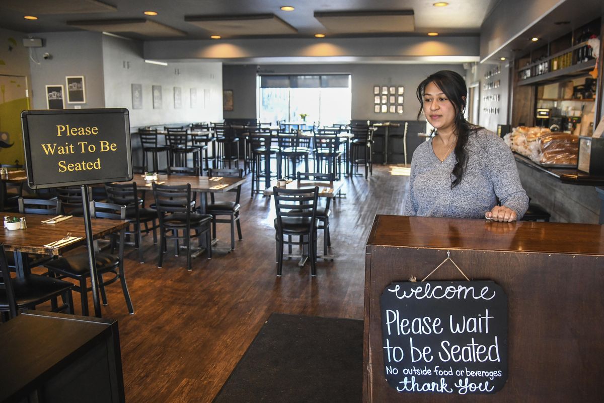 Joile Forral, owner of Bruncheonette near the Spokane County Courthouse, stands near the empty seating area mid-morning, Monday, March 16, 2020, when Gov. Jay Inslee ordered Washington restaurants and bars closed to fight the spread of the coronavirus. (Dan Pelle / The Spokesman-Review)