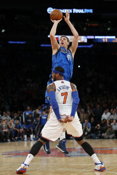 Dallas’ Dirk Nowitzki shoots the game-winning basket over New York’s Carmelo Anthony. The ball bounced up and then in. (Associated Press)