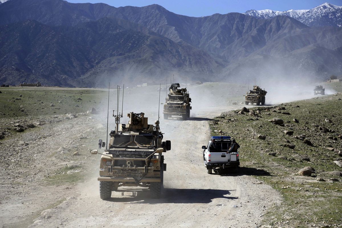 U.S. forces and Afghan commandos patrol Pandola village in April 2014 near the site of a U.S. bombing in the Achin district of Jalalabad, east of Kabul, Afghanistan.  (Rahmat Gul)