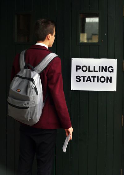 A schoolboy arrives Thursday to vote in the Scottish Referendum in Peebles, Scotland. (Associated Press)