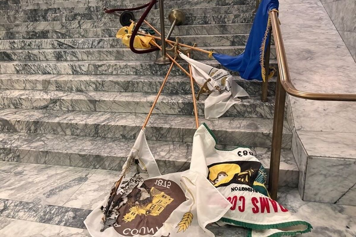 Flags lie on the ground inside the Rotunda of the Washington Capitol in Olympia following a break-in on Sunday.  (Provided photo/Department of enterprise services)