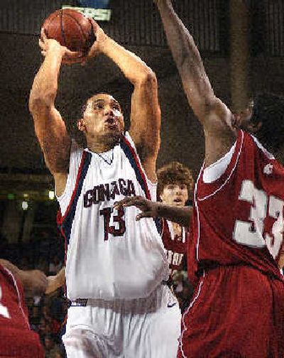 
Gonzaga center J.P. Batista fires up a jumper against visiting Washington State during Thursday's first half. 
 (Brian Plonka / The Spokesman-Review)