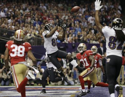 Anquan Boldin catches a 13-yard touchdown pass, one of three thrown by Joe Flacco in the first half. (Associated Press)