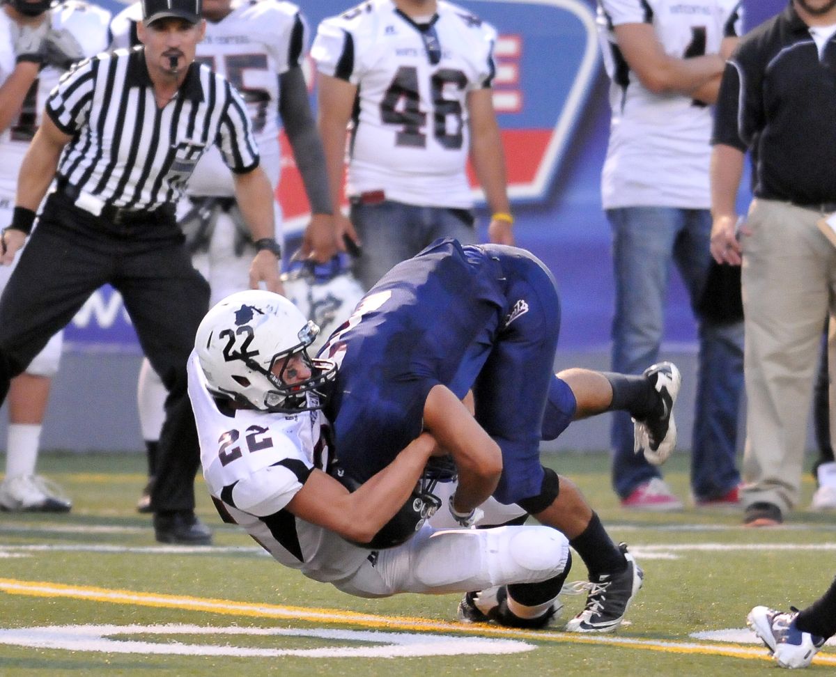 North Central’s Jimmy Weigel (22) drags down Mt. Spokane’s Daniel Munoz in the fourth quarter. (Jesse Tinsley)