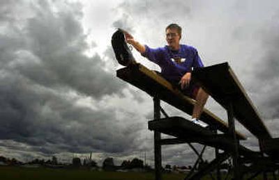 
Rogers High School cross country runner Ryan Gustafson uses the bleachers to stretch out his legs before the team departs on a training run. Gustafson is nursing an injury but hopes to be back with the team within two weeks. 
 (Christopher Anderson/ / The Spokesman-Review)