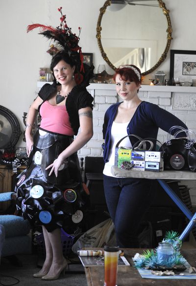 Designer and artist Kelly Lynch-Chevalier, right, made the skirt and headpiece worn by model Dev Brierley, out of old vinyl records. The two were photographed Tuesday, at Lynch-Chevalier’s home in Spokane. Lynch-Chevalier also makes purses out of cassettes and record albums, as seen on the ironing board. (Jesse Tinsley)