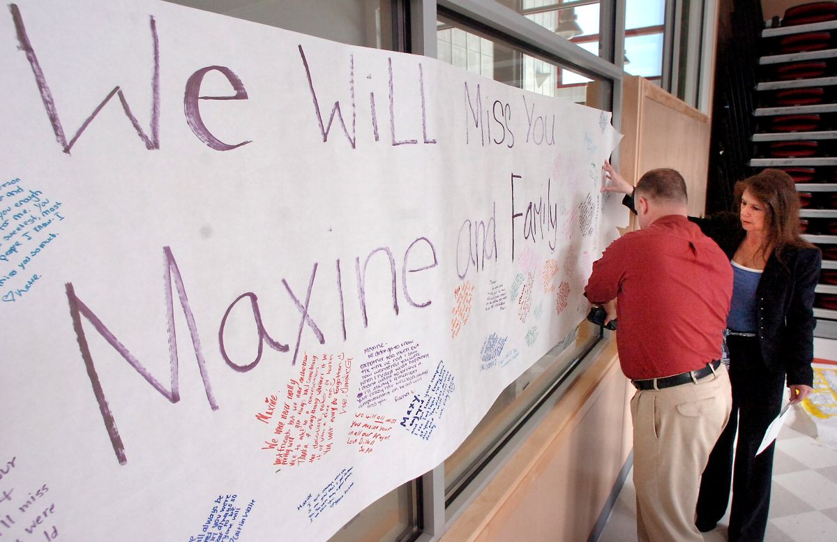 Orting High School Assistant Principal Jon Bell and Principal Doris Bolender put up a tribute banner to Maxine Harrison at Orting High School’s common area Monday.  (Associated Press / The Spokesman-Review)