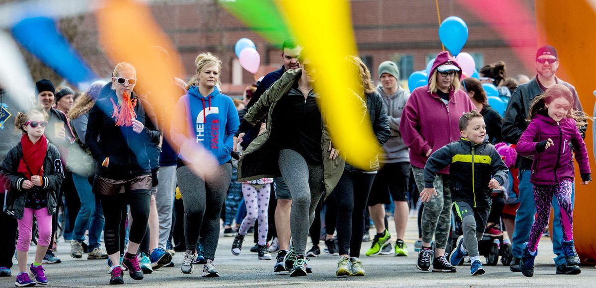 The crowd takes off at the starting line of Walk MS Spokane, a march to raise funding for the fight against multiple sclerosis, on Sunday, April 15, 2018, at Spokane Falls Community College. (Kathy Plonka / The Spokesman-Review)