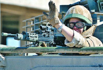 
A British soldier waves from an armored vehicle while on patrol in Basra,  southeast of Baghdad, Iraq, on Wednesday. 
 (Associated Press / The Spokesman-Review)
