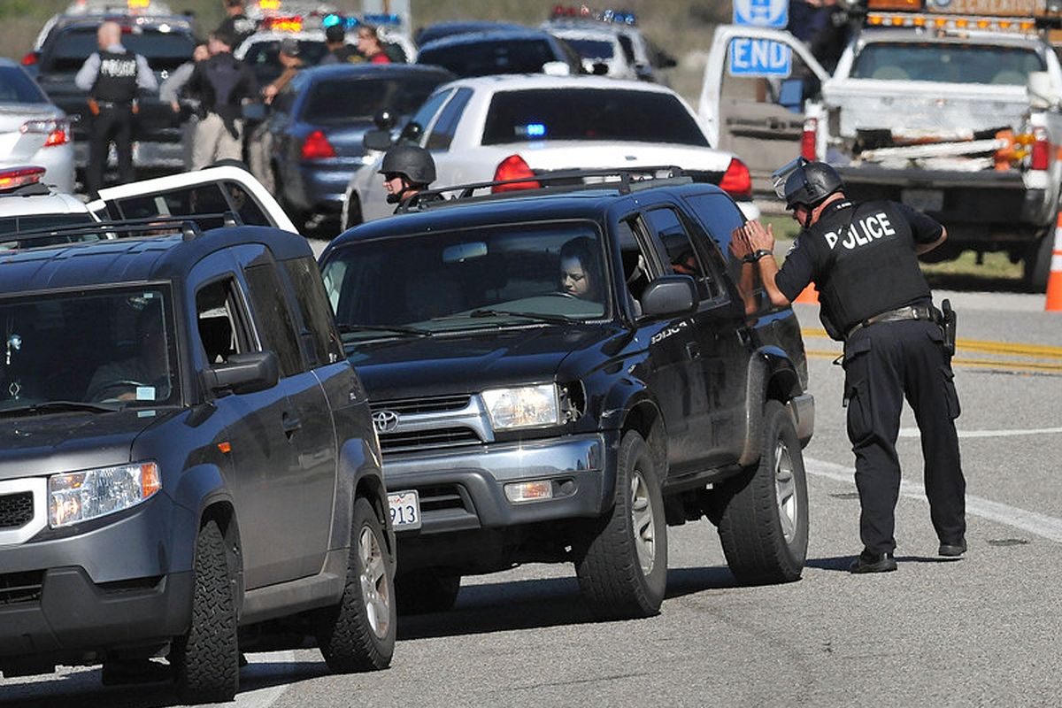 Redlands Police officers man a blockade  near the entrance to the San Bernardino National Forest in southern California after Christopher Dorner, a fugitive ex-Los Angeles cop sought in three killings, engaged in a shootout with authorities that wounded two officers in the San Bernardino Mountains near Big Bear Lake, Tuesday, Feb. 12, 2013. (Gabriel Acosta / San Bernardino Sun)