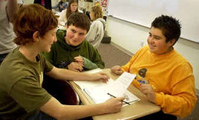 
River City Middle School eighth-grader Brett Winn, left, practices his parent-teacher conference presentation with Cody Myers, center, and Joey Roman during honors English class on Tuesday. Teacher Katherine Kosareff has her students preparing to lead their own parent-teacher conferences.  
 (Jesse Tinsley / The Spokesman-Review)