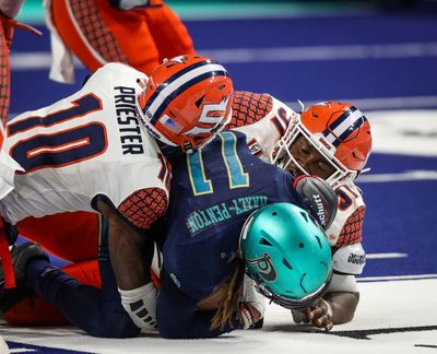 The Spokane Shock's Kyrin Priester, left, and Tre Hornbuckle, right, take down Massachusetts Pirates receiver Aaron Maxey-Penton on Saturday night in Worcester, Massachusetts.   (Courtesy of Dylan Arazi )