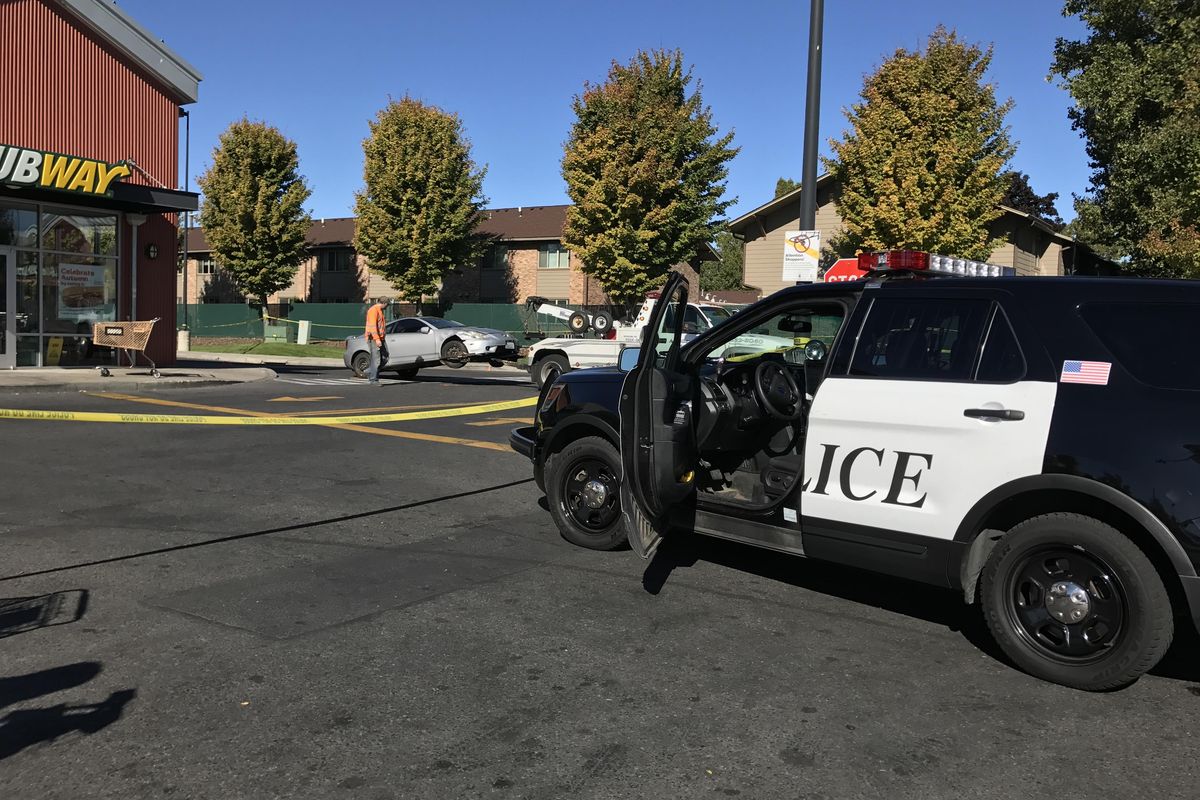 Spokane police investigated the scene of auto vs pedestrian collision near the Safeway on North Market Street Sunday, Oct. 8, 2017, that resulted in one death and two injuries. (Jonathan Glover / The Spokesman-Review)