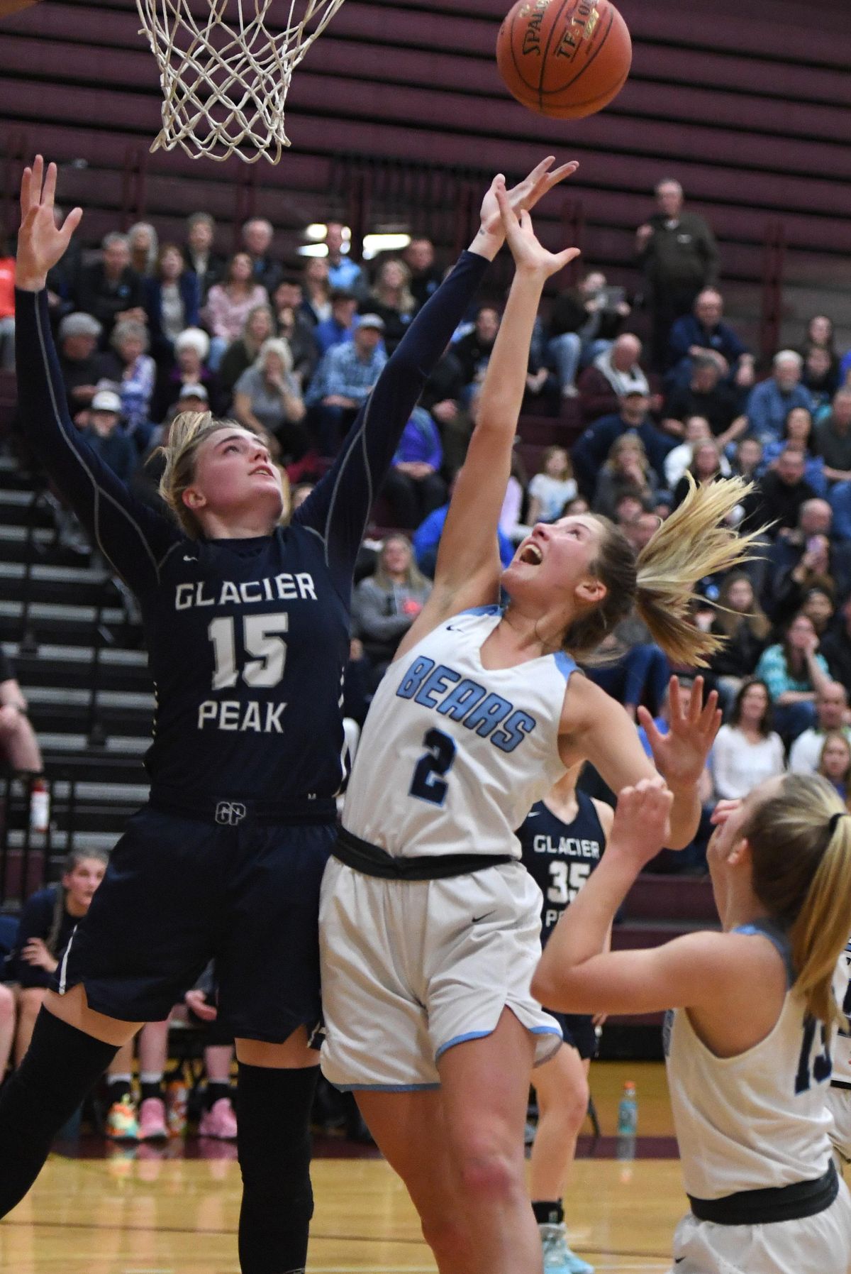 Central Valley forward Michael Pitts (2) and Glacier Peak post Madison Rubino (15) reach for a rebound during a girls 4A regional high school basketball playoff game, Friday, Feb. 28, 2020, at University High School. (Colin Mulvany / The Spokesman-Review)