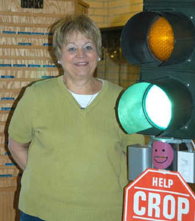 
Madelyn Bafus stands by a working stoplight at Spokane Valley United Methodist Church that reminds members to donate toward hunger relief. The Fig Tree
 (The Fig Tree / The Spokesman-Review)
