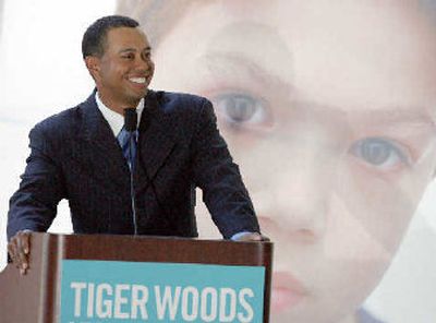 
Tiger Woods was all smiles at his grand opening on Friday. 
 (Associated Press / The Spokesman-Review)