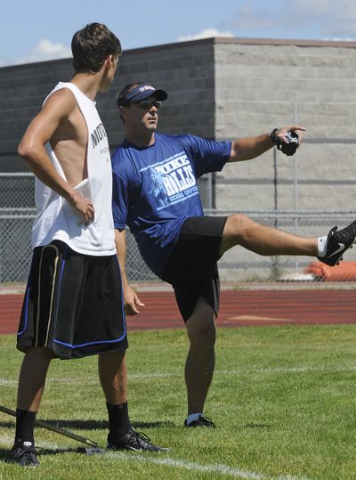 Mike Hollis, right, former, NFL, University of Idaho and Central Valley High School kicking standout, works with Zach Mohr, 16 of Deer Park, during Hollis’ kicking camp July 23 at CV. (Dan Pelle)