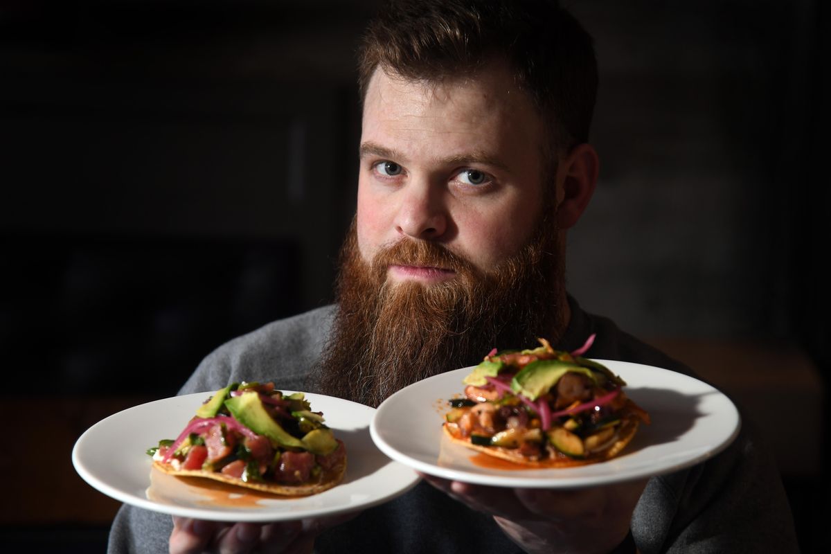 Chef Chad White holds his tuna and octopus ceviches at his Zona Blanca ceviche bar in the Steel Barrel Taproom in 2018. White made the semifinal list of James Beard Awards on Wednesday, Feb. 26, 2020. (Dan Pelle / The Spokesman-Review)