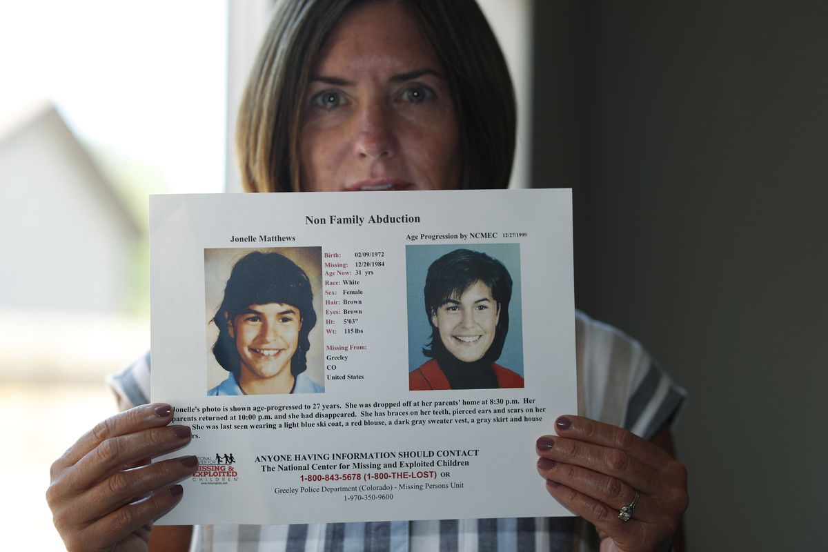 Jennifer Mogensen holds a poster in 2019 of her adopted sister, Jonelle Matthews, who went missing and whose remains were found in Greeley, Colo.  (David Zalubowski)