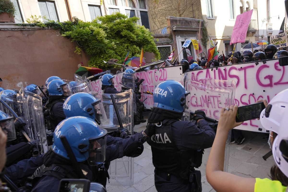 Italian Policemen in riot gears clash with demonstrators during a protest against the G20 Economy and Finance ministers and Central bank governors