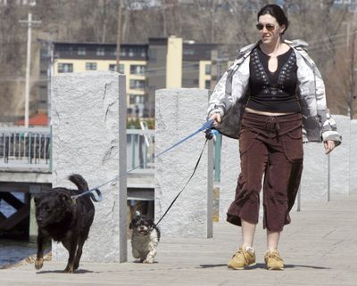 In this April 9  photo, Katie Klingerman walks her dogs, Casey and Luna, along the waterfront in Burlington, Vt.  (File Associated Press / The Spokesman-Review)