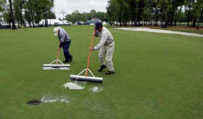
Groundskeepers move water to a drain in the first fairway at the TPC of Louisiana course, site of the Zurich Classic. Storms prevented the completion of the third round.
 (Associated Press / The Spokesman-Review)