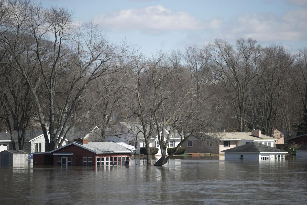 The Rock River crested its banks and floods Shore Drive, seen here on Saturday from the Bauer Parkway bridge in Machesney Park, Illinois. Many rivers and creeks in the Midwest are at record levels after days of snow and rain. (Scott P. Yates / AP)
