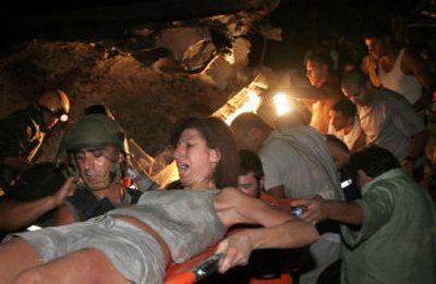 
A woman is rescued from rubble at the site of a Hezbollah rocket attack Sunday in the northern Israel town of Haifa. 
 (Associated Press / The Spokesman-Review)