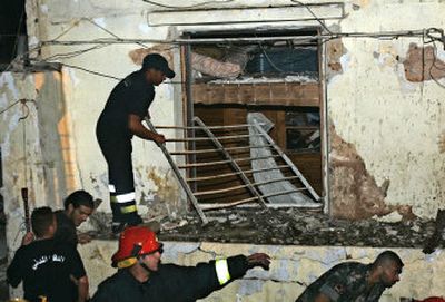 
Lebanese civil defense workers remove debris from a damaged house on the scene of an exploded car in Beirut. 
 (Associated Press / The Spokesman-Review)