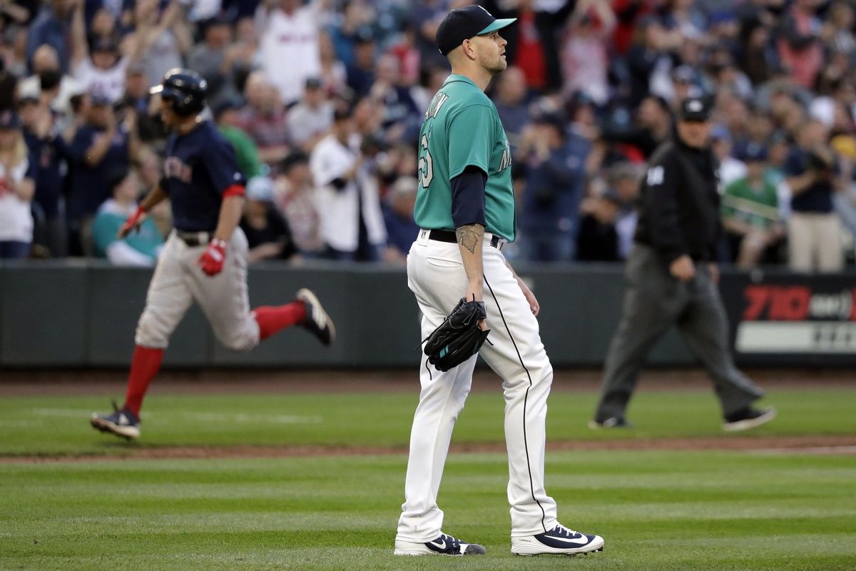 Seattle Mariners starting pitcher James Paxton stands near the mound as Boston Red Sox’s Xander Bogaerts, left, rounds the bases after hitting a three-run home run during the third inning Friday in Seattle. (Ted S. Warren / AP)