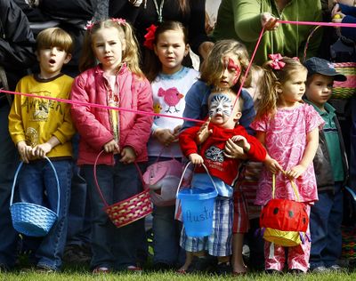 ORG XMIT: ORROS101 An unidentified little boy gets stuck in a ribbon as he waits with other children for the start of the annual Easter egg hunt at Stewart Park in Roseburg, Ore., on Saturday, April 11, 2009. During the hunt children scooped up about 10,000 candy-filled plastic eggs at the park. (AP Photo/The News-Review, Robin Loznak) (Robin News-review / The Spokesman-Review)