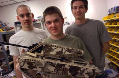 
Kriston Broxson, holding a battle tank, Levi Wilson, left, and Tim Lines  are product development engineers working on MINDS-i, a customizable construction toy developed in Liberty Lake. 
 (Photos by Dan Pelle / The Spokesman-Review)