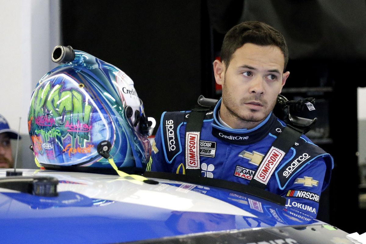 FILE - In this Feb. 14, 2020, file photo, Kyle Larson gets ready to climb into his car to practice for the NASCAR Daytona 500 auto race at Daytona International Speedway in Daytona Beach, Fla. NASCAR on Monday, Oct. 29, 2020, cleared Larson to return in 2021, ending his long suspension for using a racial slur while playing a video racing game. Larson was suspended in April after he used the n-word while playing an online racing game in which viewers could follow along.  (Terry Renna)