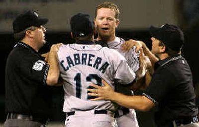 
Seattle pitcher Ryan Franklin is restrained  as he has words with Anheim manager Mike Scioscia  after Franklin hit Angels batter Vladimir Guerrero in the first inning.
 (Associated Press / The Spokesman-Review)