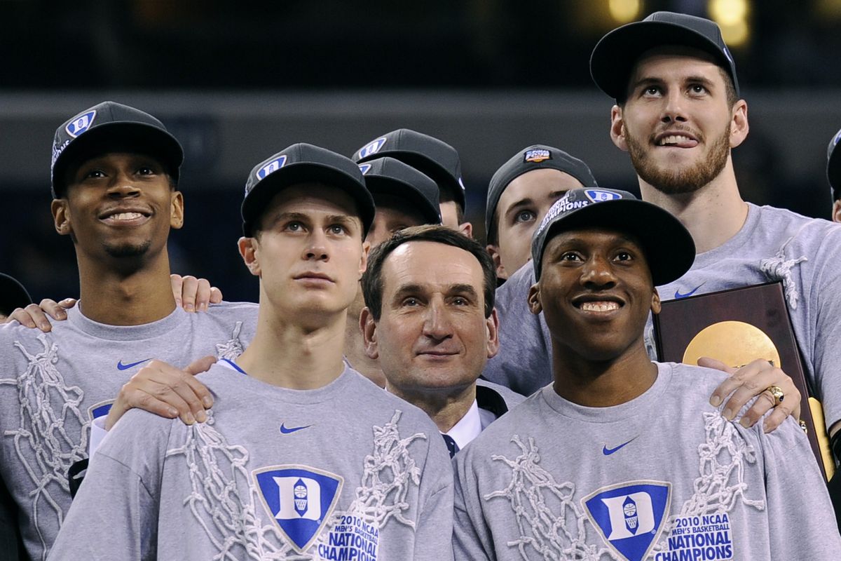 Duke players encircle head coach Mike Krzyzewski after winning NCAA title.  (Associated Press)